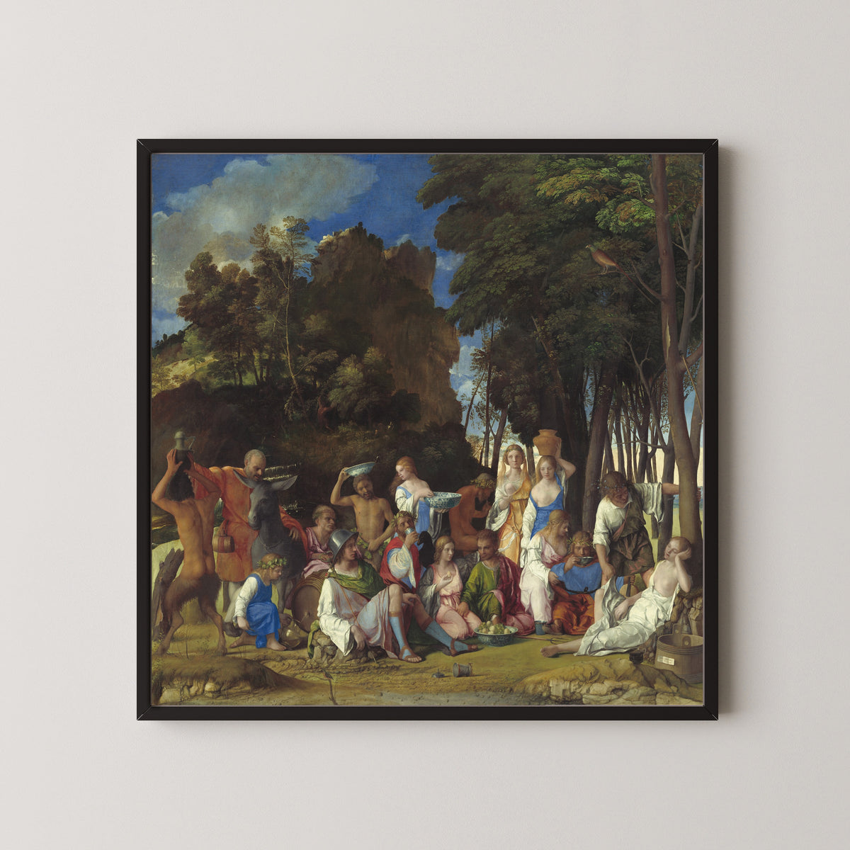 Framed art print of The Feast of the Gods by Giovanni Bellini, in a black frame on a pale wall