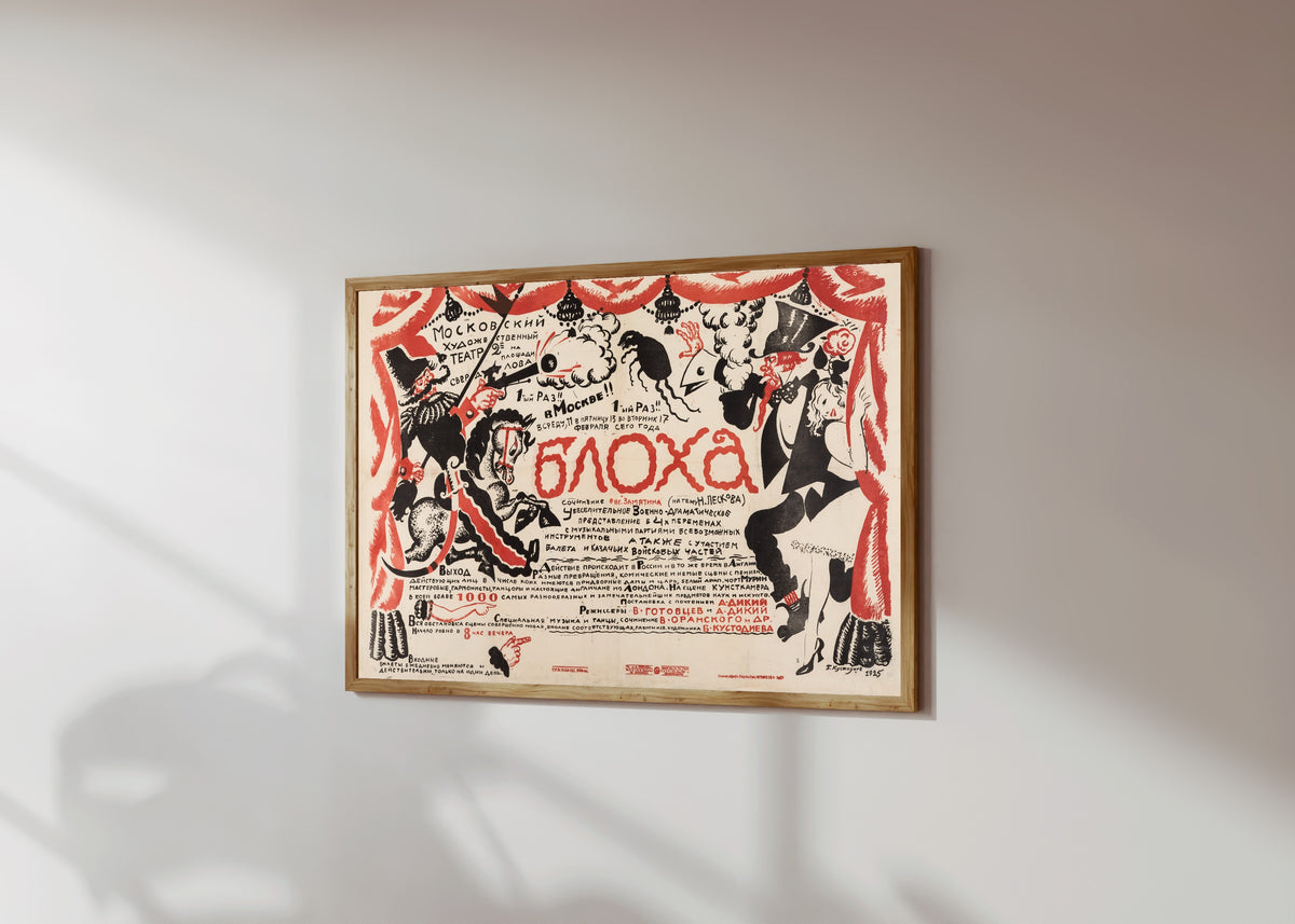Framed art print of The Flea (Moscow Art Theatre production) by Boris Kustodiev, in a light wood frame on a sunlit white wall, seen at a slight angle