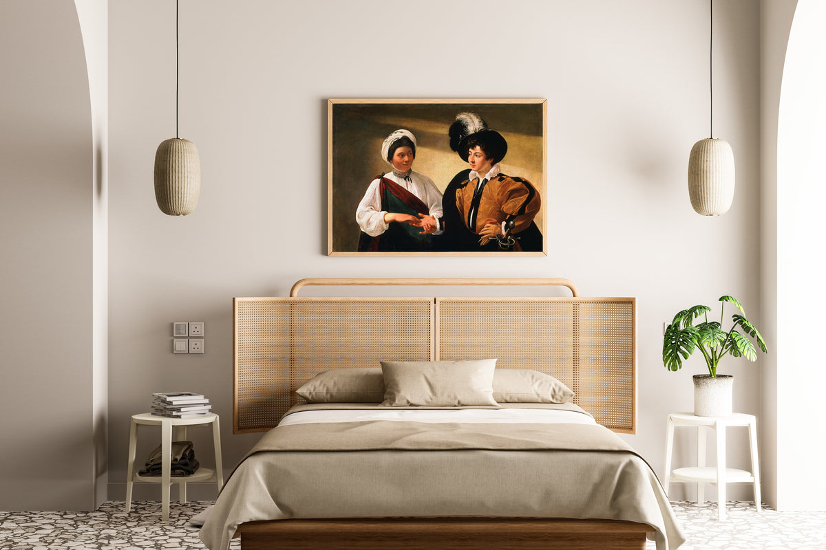 Framed art print of The Fortune Teller by Caravaggio, above a cane-headboard bed