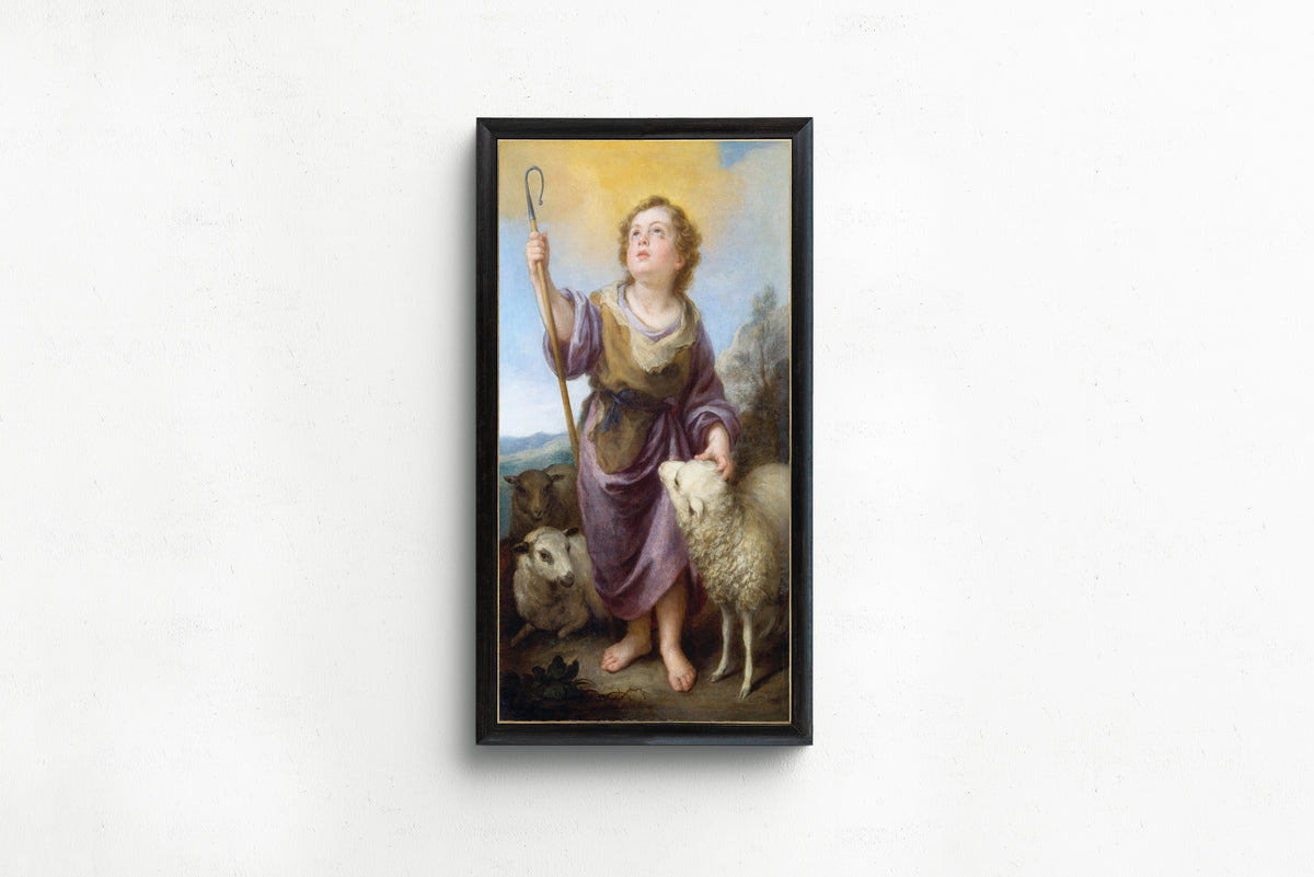 Framed art print of The Good Shepherd by Bartolomé Esteban Murillo, in a slim black frame on a plain white wall