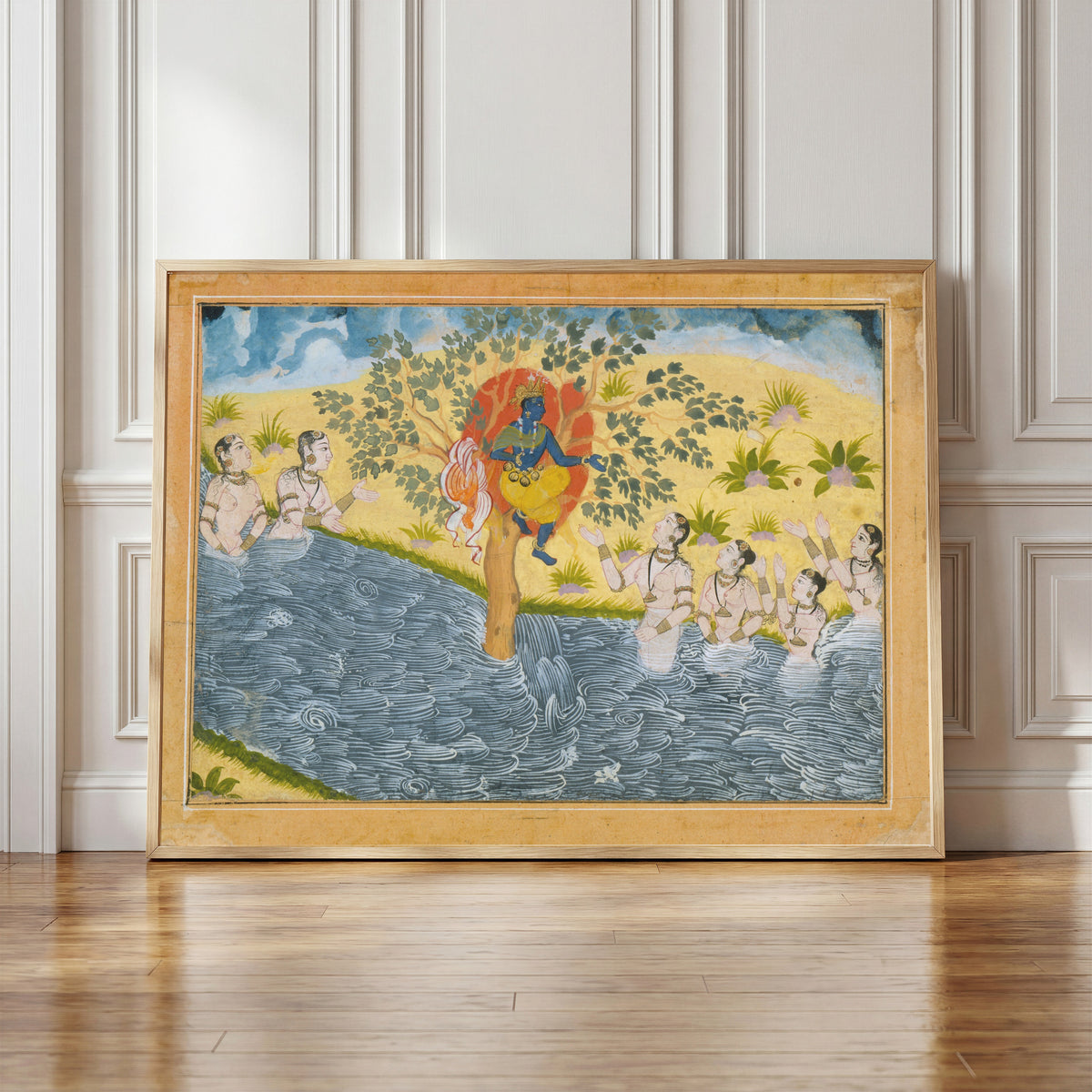 Framed art print of The Gopis Plead with Krishna to Return Their Clothing by Bikaner school, in a light wood frame leaning against a panelled white wall