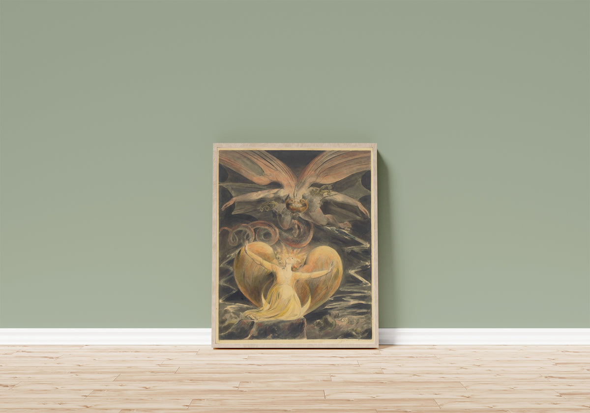 Framed art print of The Great Red Dragon and the Woman Clothed with… by William Blake, in a light wood frame leaning on a sage green wall above a wooden floor