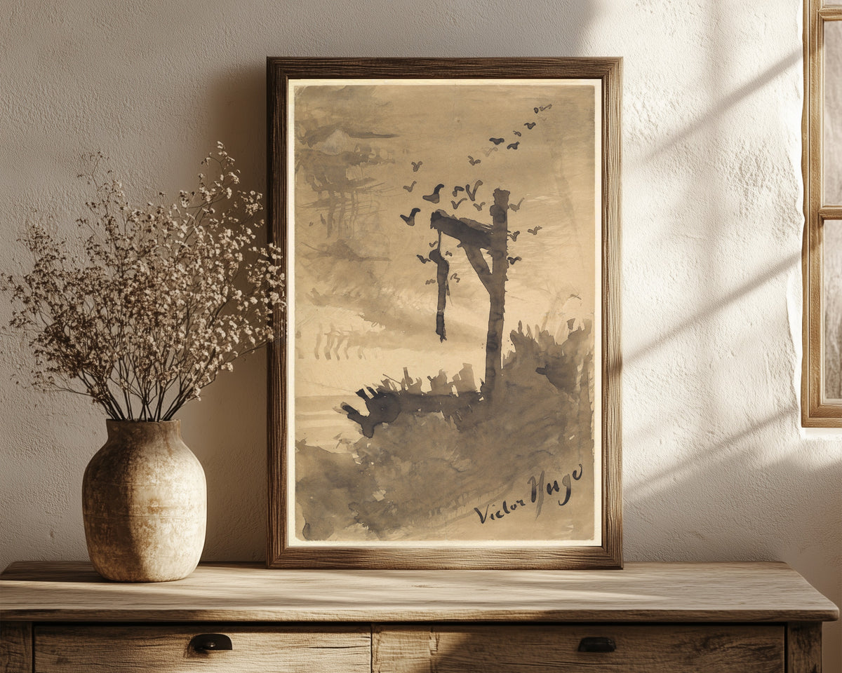 Framed art print of The Hanged Man by Victor Hugo, in a dark wood frame leaning on a rustic console beside dried flowers