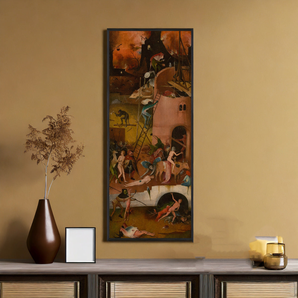 Framed art print of The Haywain Triptych - Hell (right wing) by Hieronymus Bosch, on an ochre wall above a console table