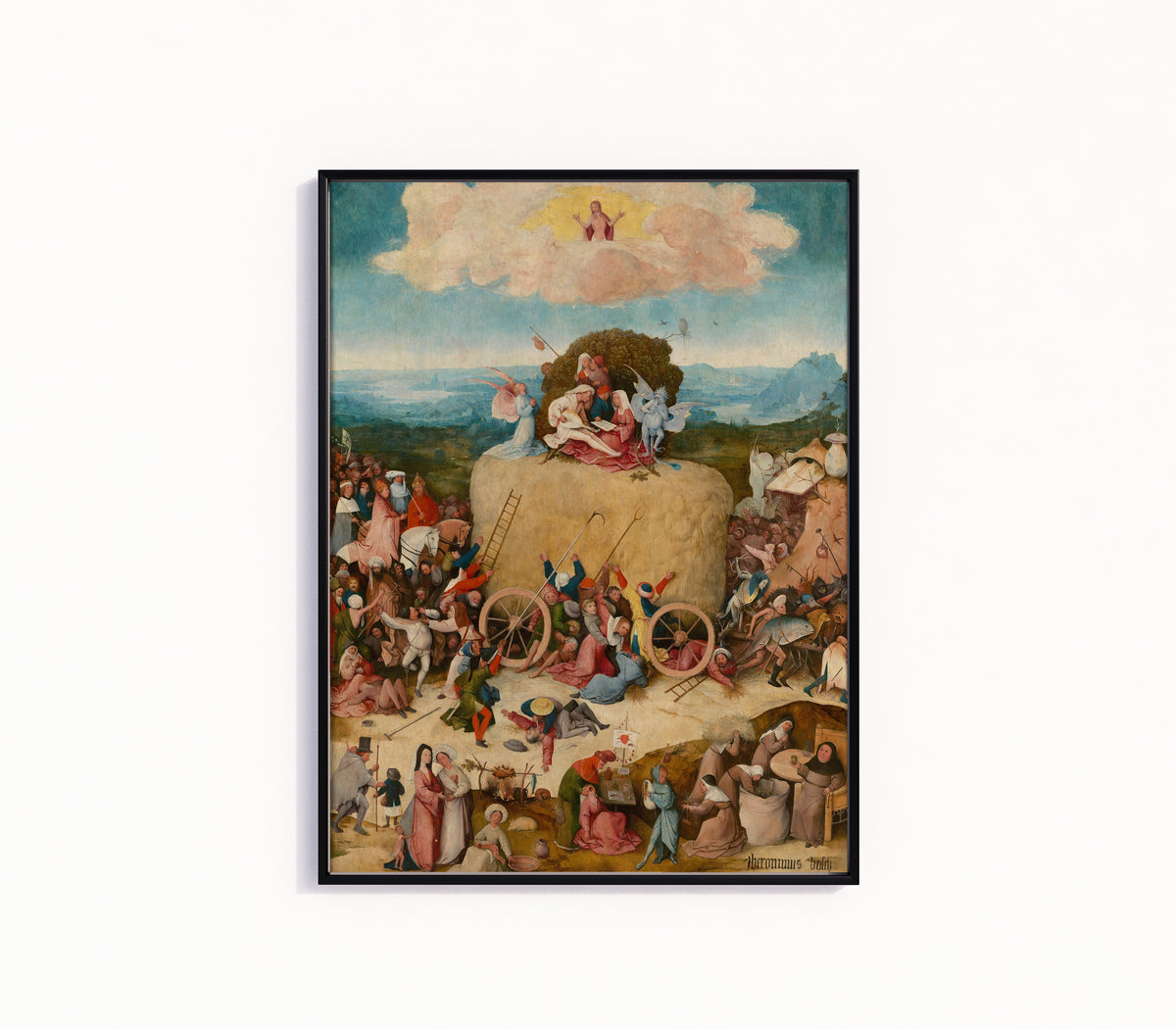 Framed art print of The Haywain Triptych (central panel) by Hieronymus Bosch, in a slim black frame on a plain white wall