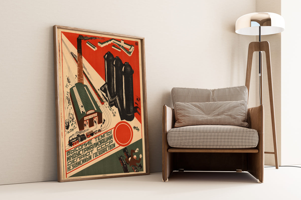 Framed art print of The High Pace of Industrialisation Makes the USSR an Independent State, leaning against a wall beside an armchair and a floor lamp