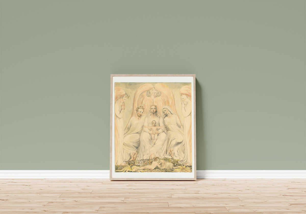 Framed art print of The Holy Family (Christ in the Lap of Truth) by William Blake, in a light wood frame leaning on a sage green wall above a wooden floor