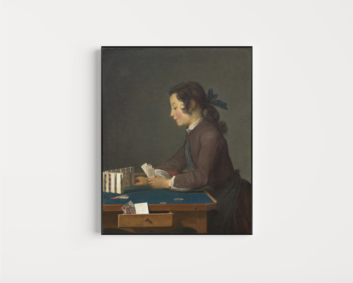 Framed art print of The House of Cards by Jean-Siméon Chardin, in a slim black frame on a plain white wall