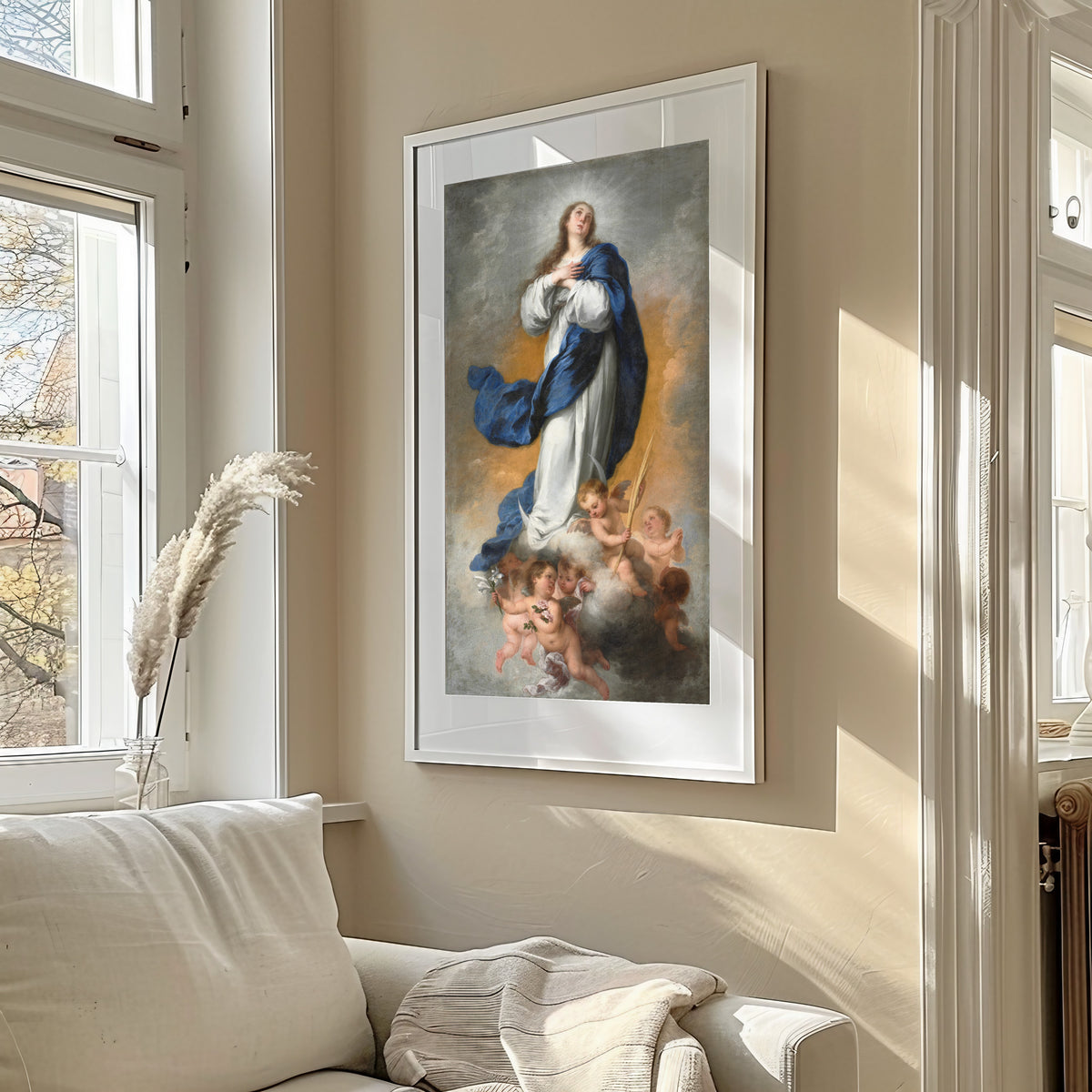 Framed art print of The Immaculate Conception by Bartolomé Esteban Murillo, in a sunlit living room above a sofa