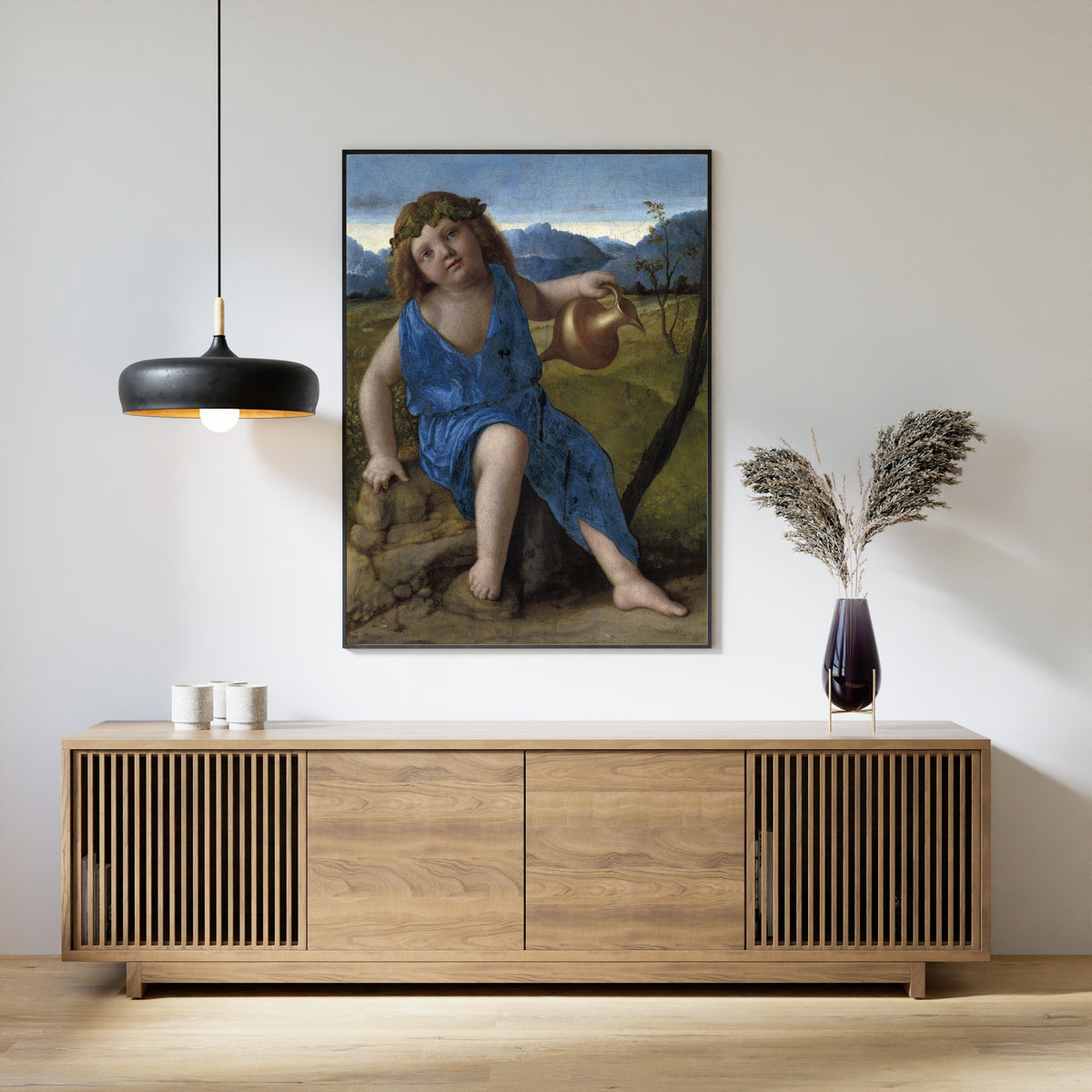 Framed art print of The Infant Bacchus by Giovanni Bellini, above a slatted wood sideboard