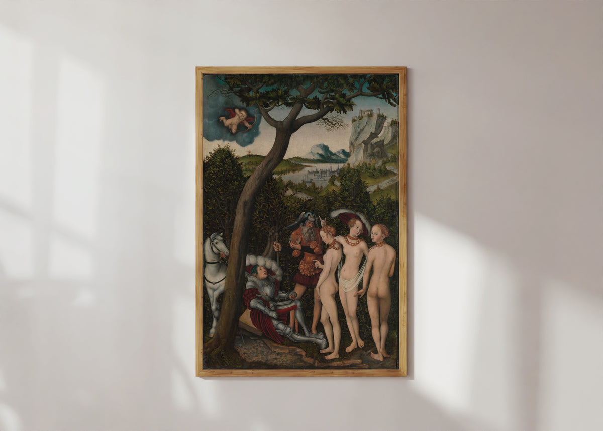 Framed art print of The Judgment of Paris by Lucas Cranach the Elder, in a light wood frame on a sunlit white wall