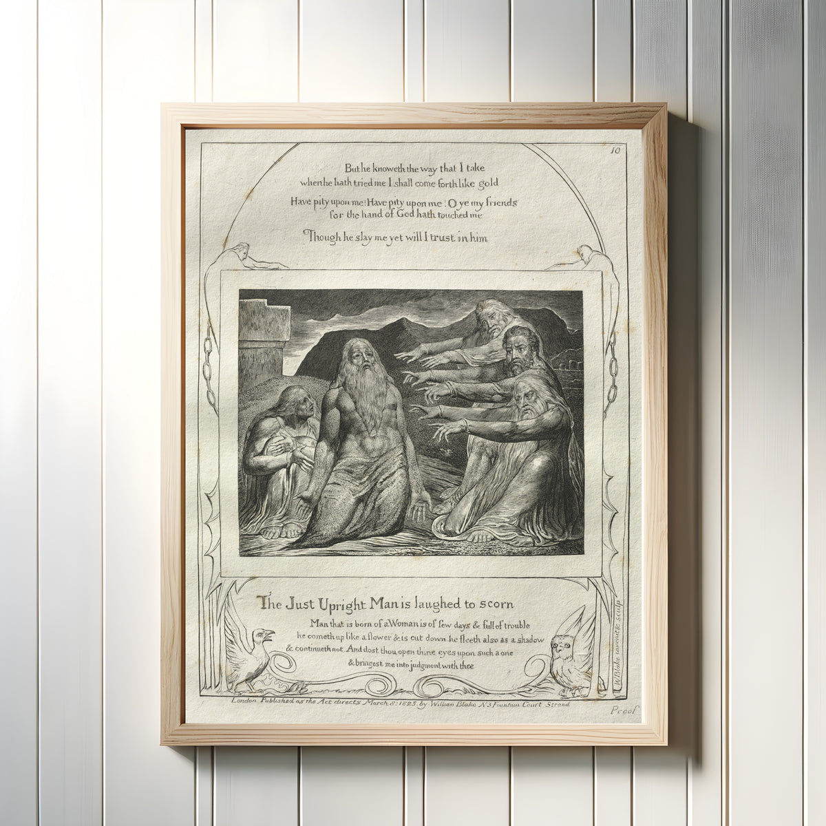 Framed art print of The Just Upright Man Is Laughed to Scorn (Book of Job, Plate 10) by William Blake, in a light wood frame on a white panelled wall
