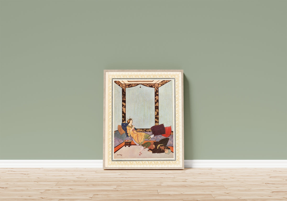 Framed art print of The Lady Bedr-el-Budur and the wicked Magician by Edmund Dulac, in a light wood frame leaning on a sage green wall above a wooden floor