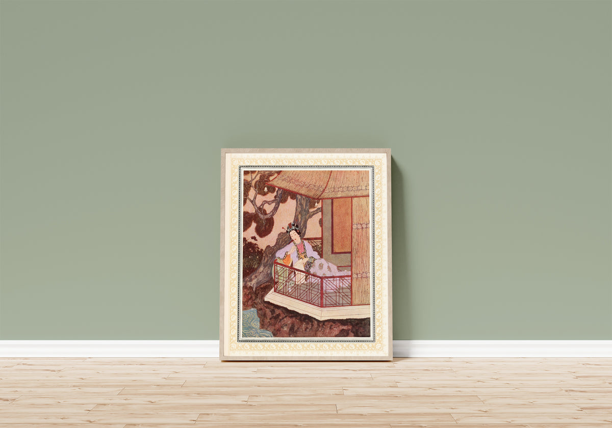 Framed art print of The Lady Bedr-el-Budur by Edmund Dulac, in a light wood frame leaning on a sage green wall above a wooden floor