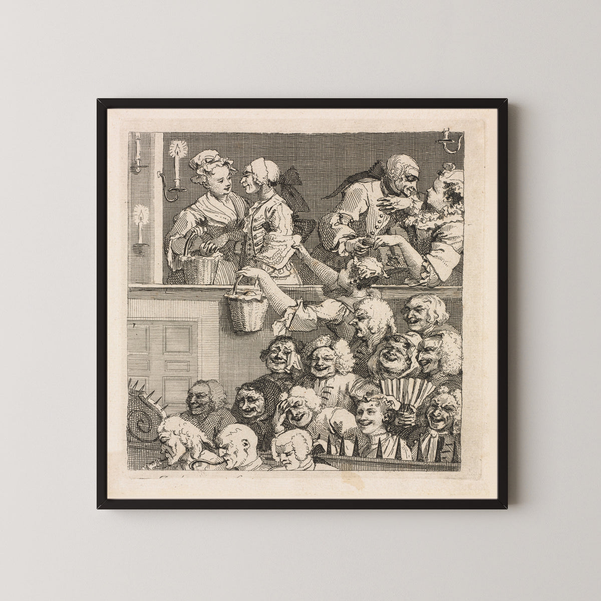 Framed art print of The Laughing Audience by William Hogarth, in a black frame on a pale wall