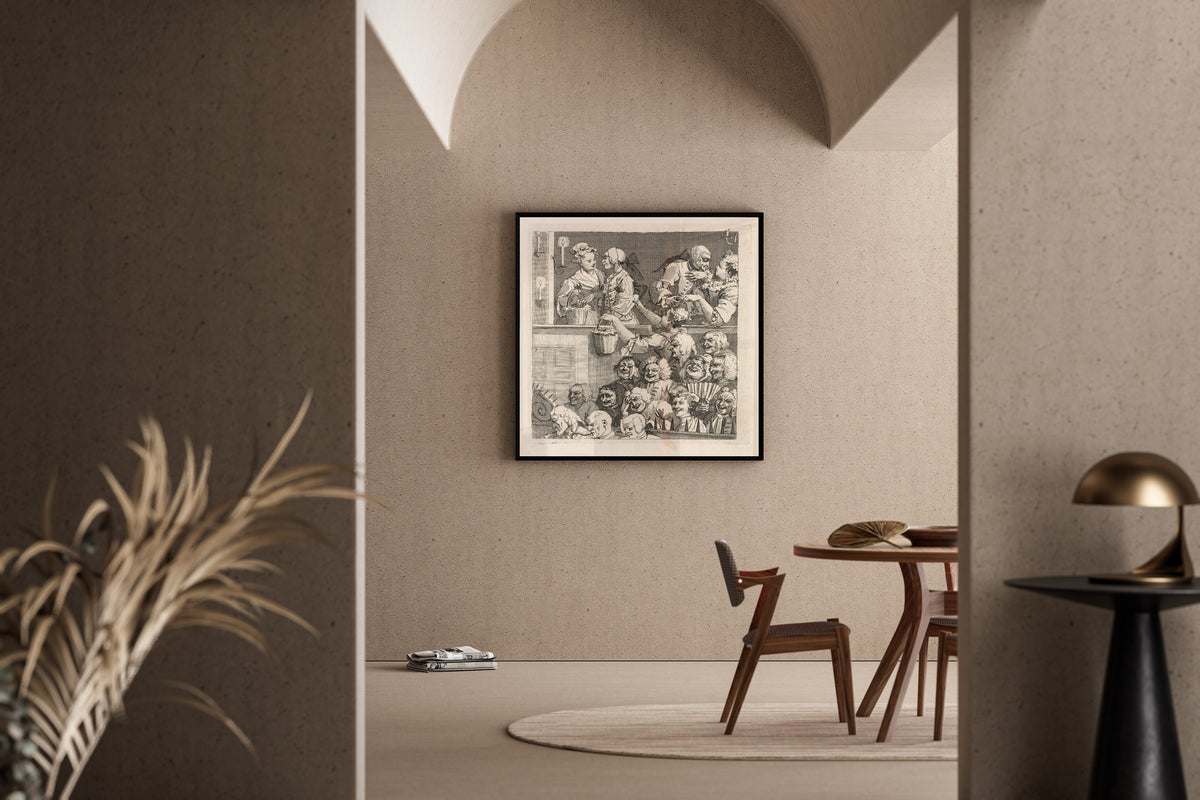 Framed art print of The Laughing Audience by William Hogarth, in a sunlit dining corner