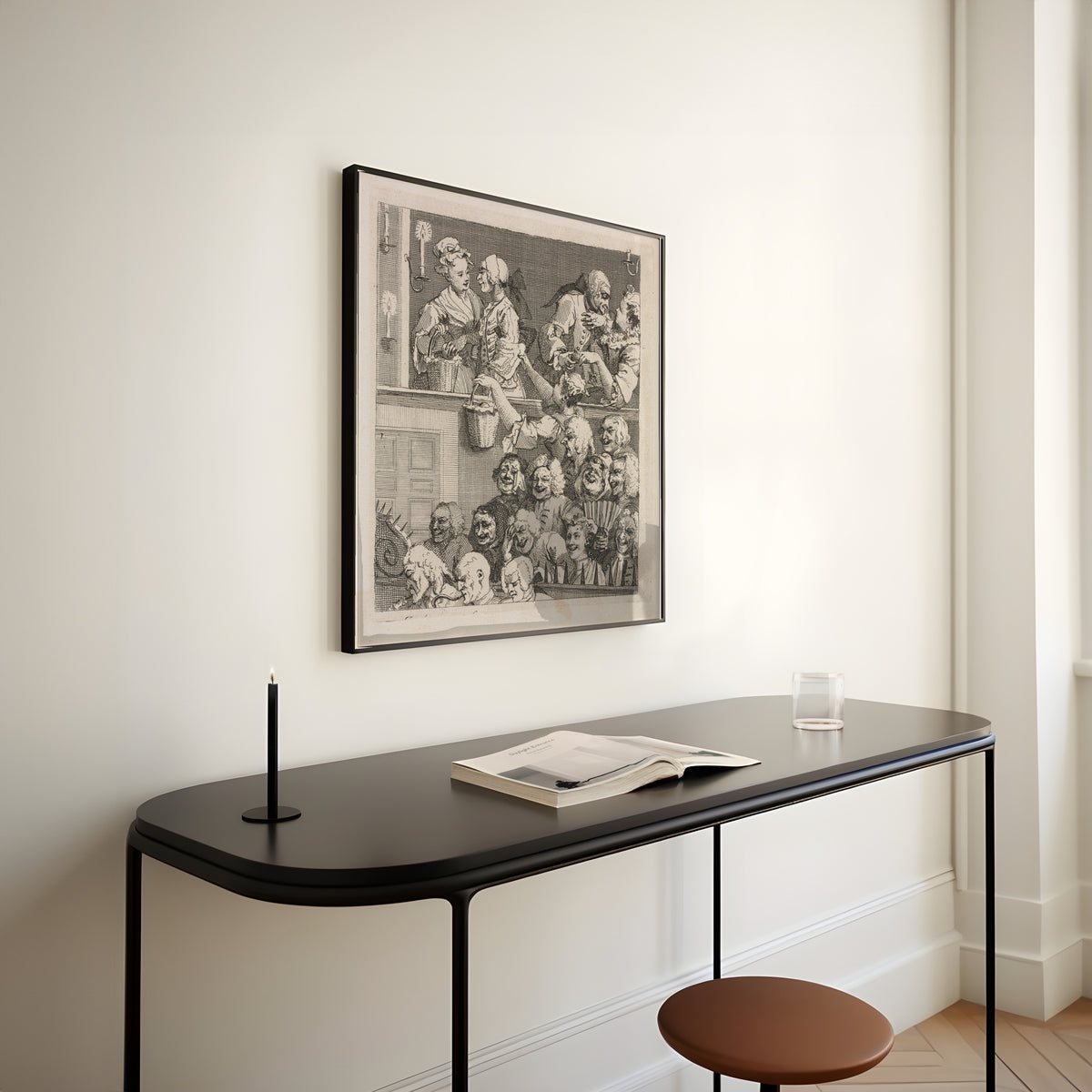 Framed art print of The Laughing Audience by William Hogarth, above a slim black console table