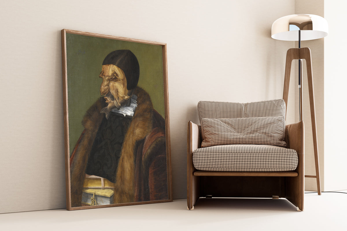 Framed art print of The Lawyer by Giuseppe Arcimboldo, leaning against a wall beside an armchair and a floor lamp