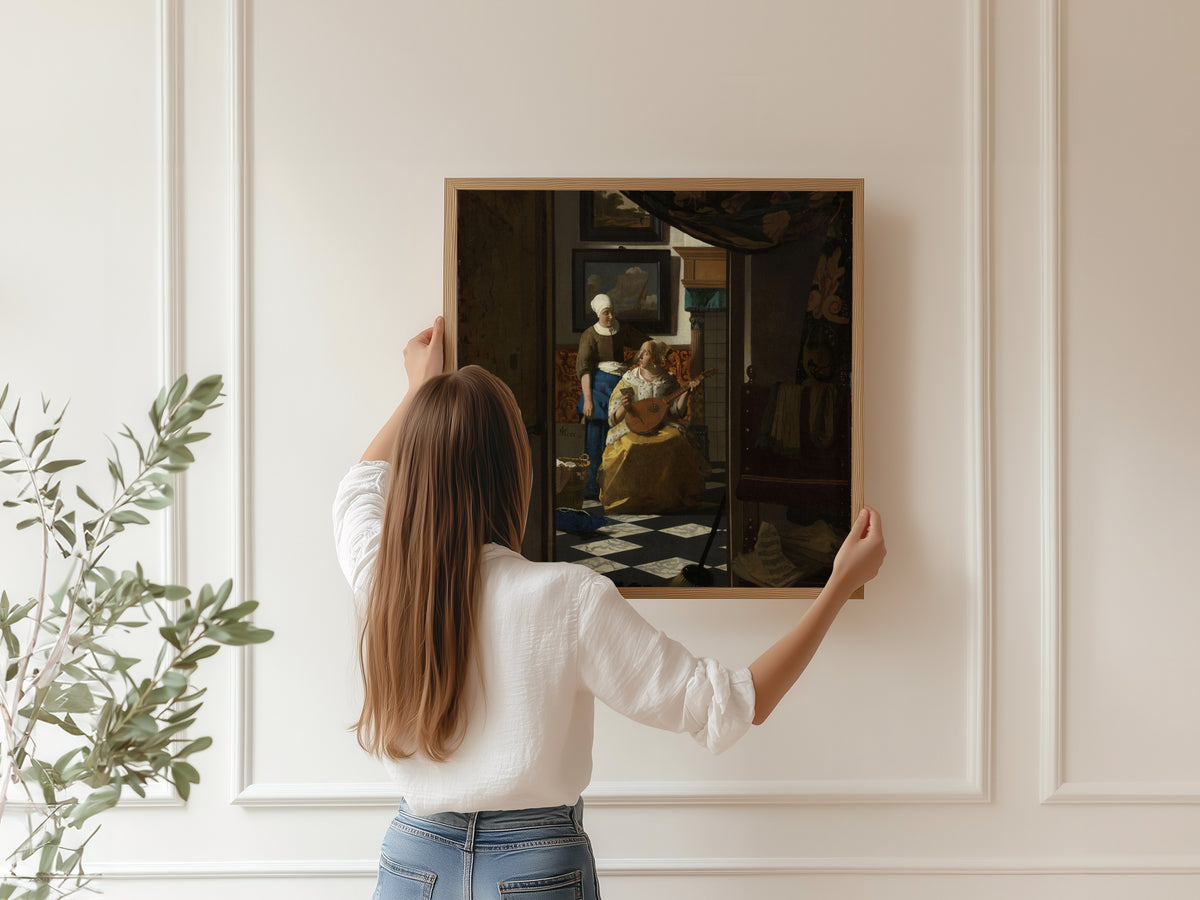 Framed art print of The Love Letter by Johannes Vermeer, hung on a panelled wall