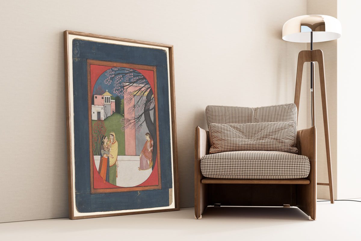 Framed art print of The Lovelorn Heroine by Pahari school, leaning against a wall beside an armchair and a floor lamp