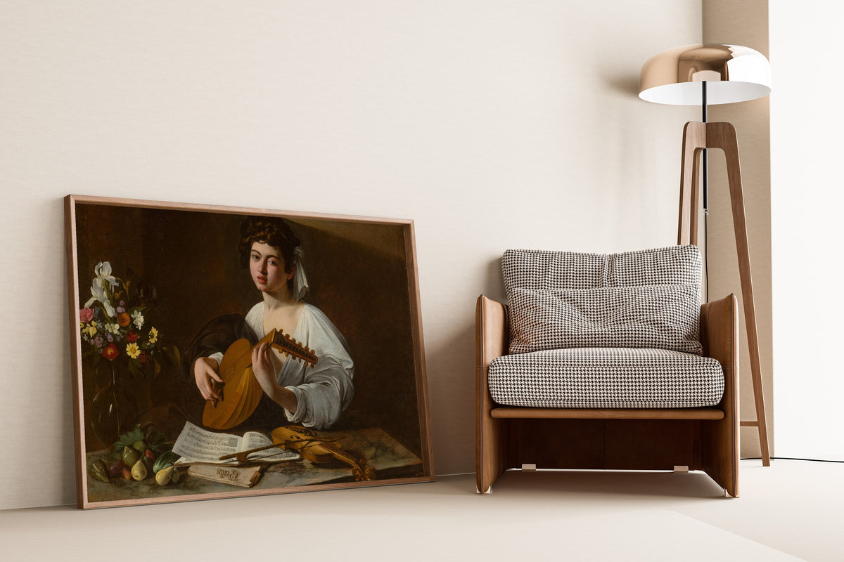 Framed art print of The Lute Player by Caravaggio, leaning against a wall beside an armchair and a floor lamp