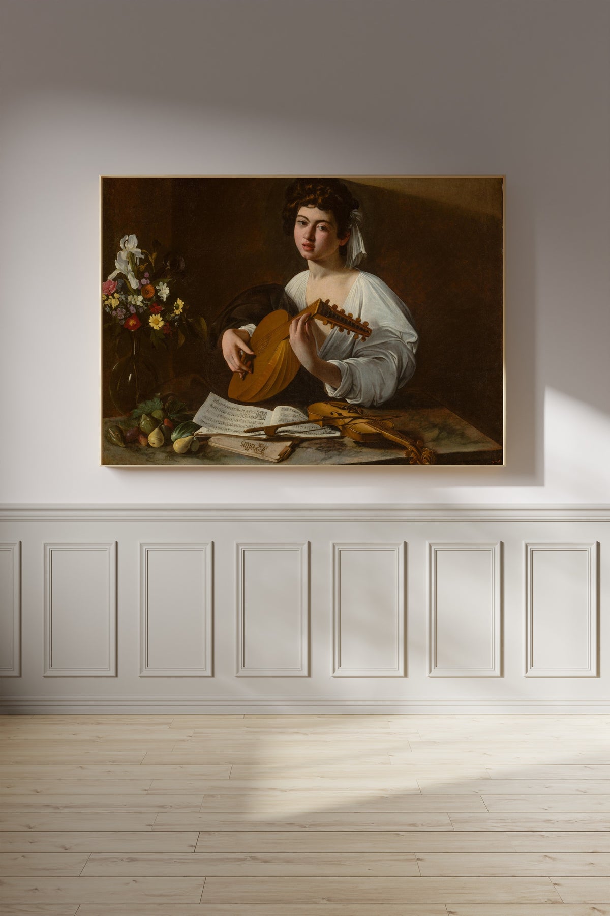 Framed art print of The Lute Player by Caravaggio, on a panelled wall in afternoon light