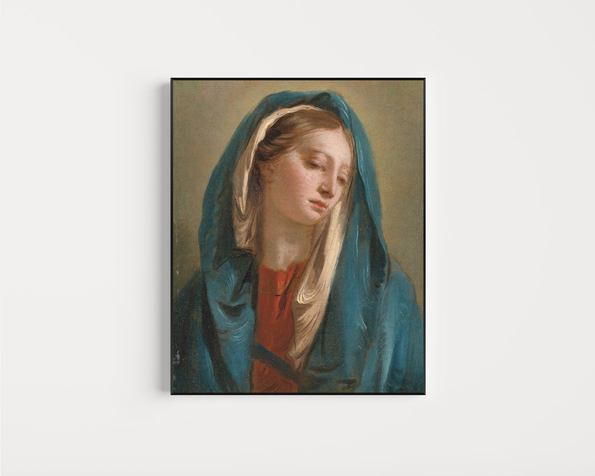 Framed art print of The Madonna Facing Front and Wearing a Blue Cloak by Giovanni Battista Tiepolo, in a slim black frame on a plain white wall