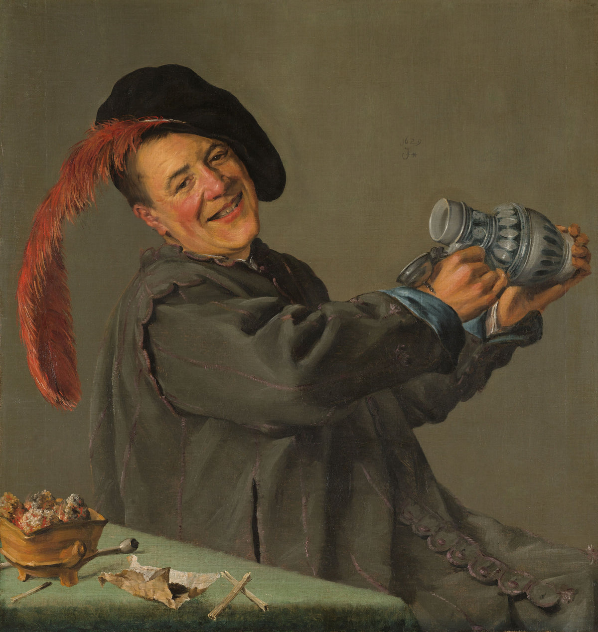 The Merry Drinker by Judith Leyster — A tipsy drinker in a red-plumed beret grins and shakes an empty jug