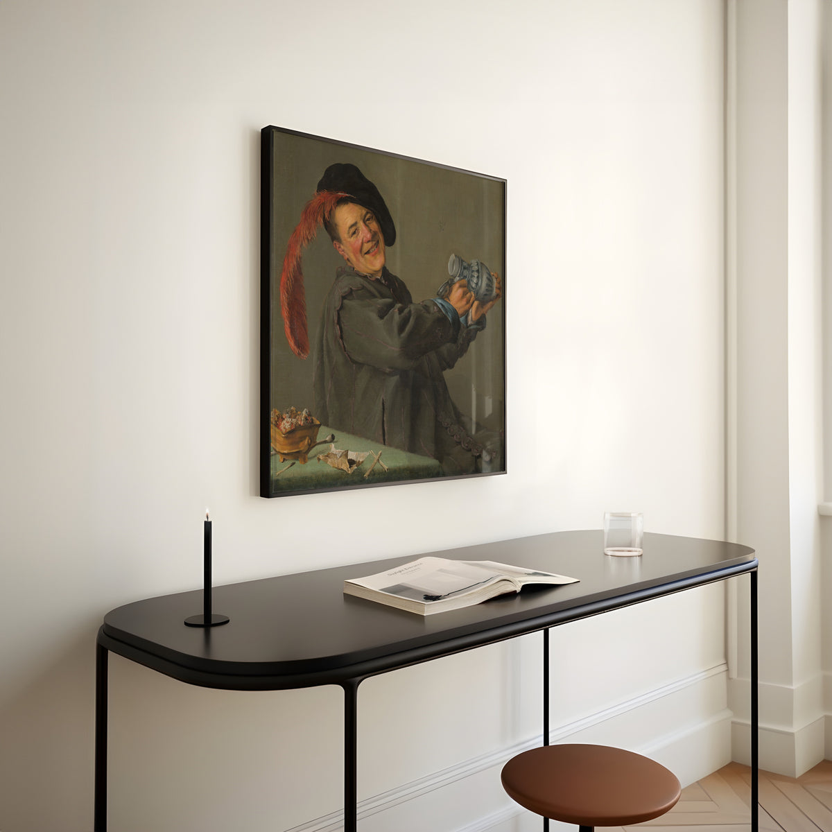 Framed art print of The Merry Drinker by Judith Leyster, above a slim black console table