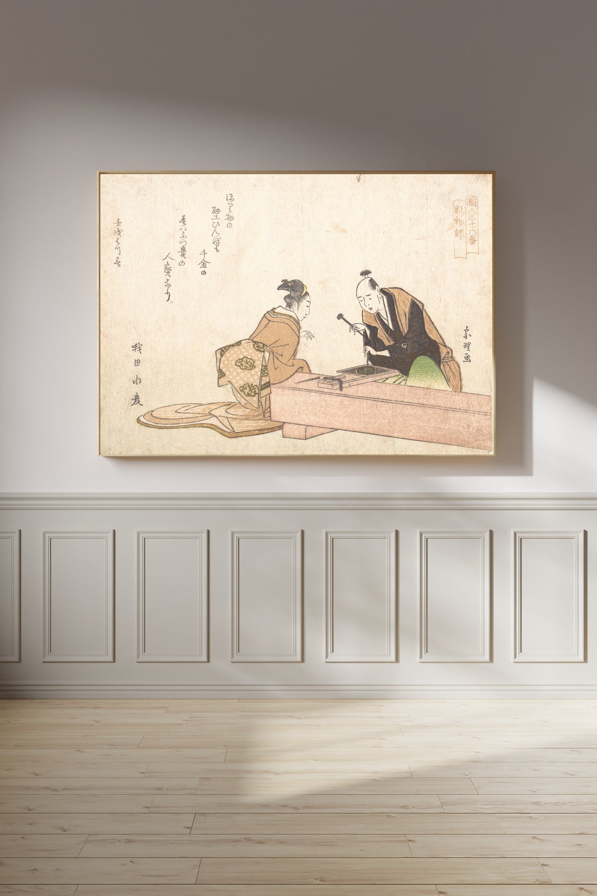 Framed art print of The Metal Carver by Katsushika Hokusai, on a panelled wall in afternoon light