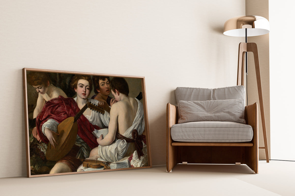 Framed art print of The Musicians by Caravaggio, leaning against a wall beside an armchair and a floor lamp