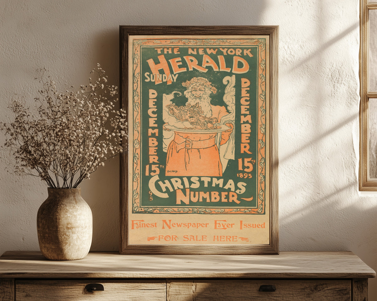 Framed art print of The New York Herald, Sunday, December 15 by Louis Rhead, in a dark wood frame leaning on a rustic console beside dried flowers