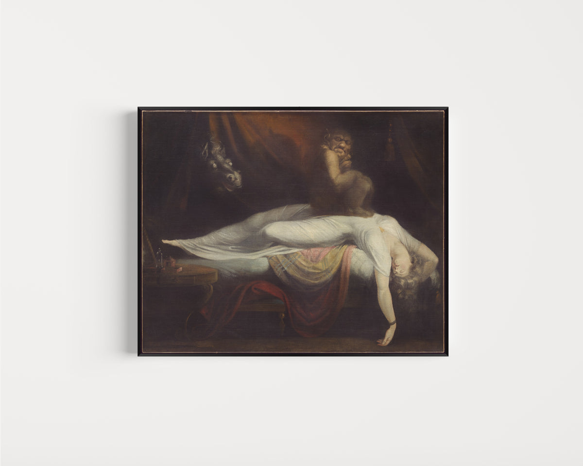 Framed art print of The Nightmare by Henry Fuseli, in a slim black frame on a plain white wall