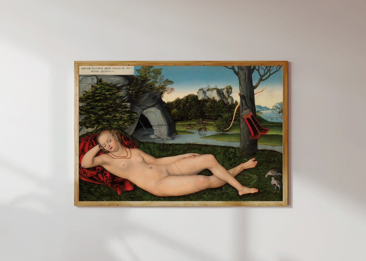 Framed art print of The Nymph of the Spring by Lucas Cranach the Elder, in a light wood frame on a sunlit white wall