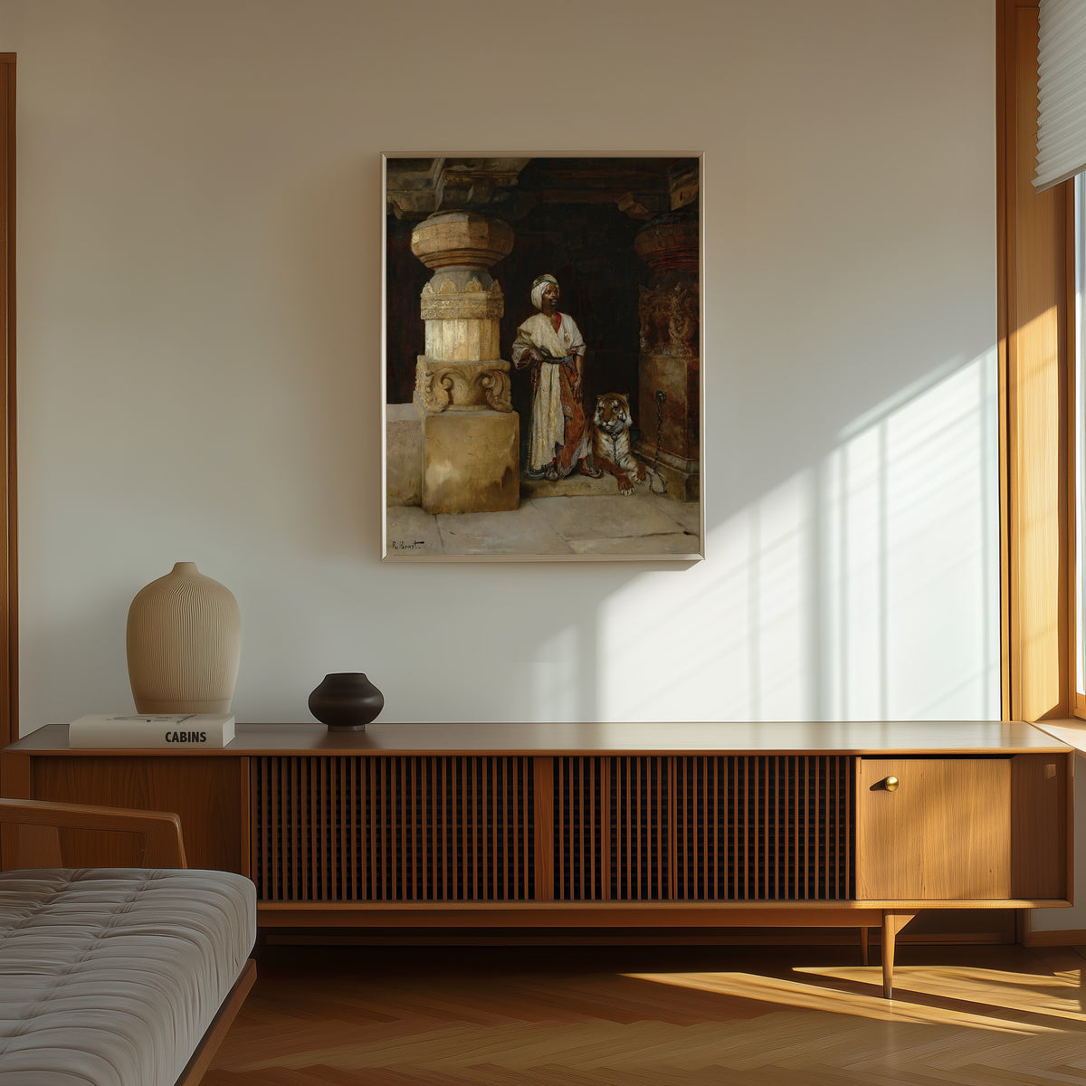 Framed art print of The Palace Guard (with tiger) by Rudolf Ernst, in a thin light frame on a sunlit wall above a wooden sideboard
