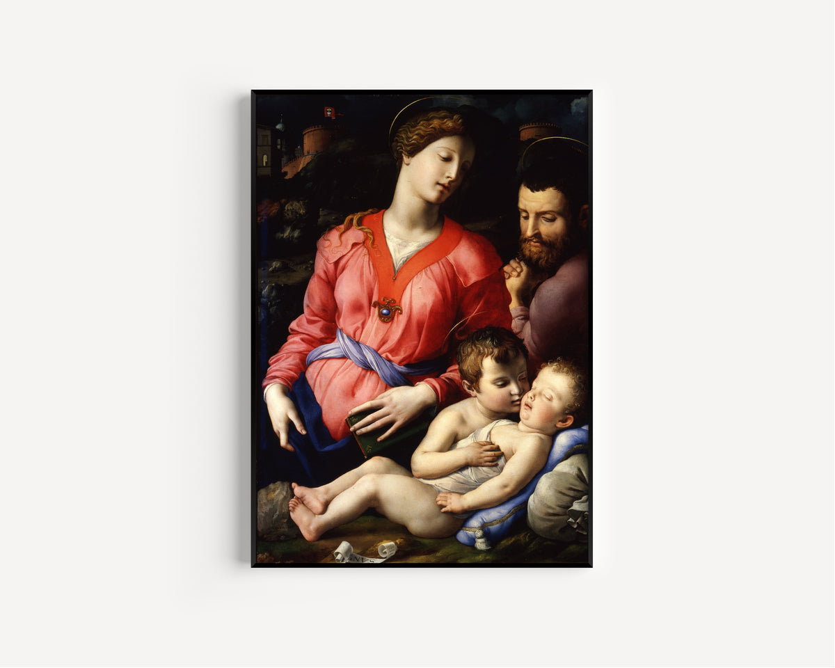 Framed art print of The Panciatichi Holy Family by Bronzino, in a slim black frame on a plain white wall