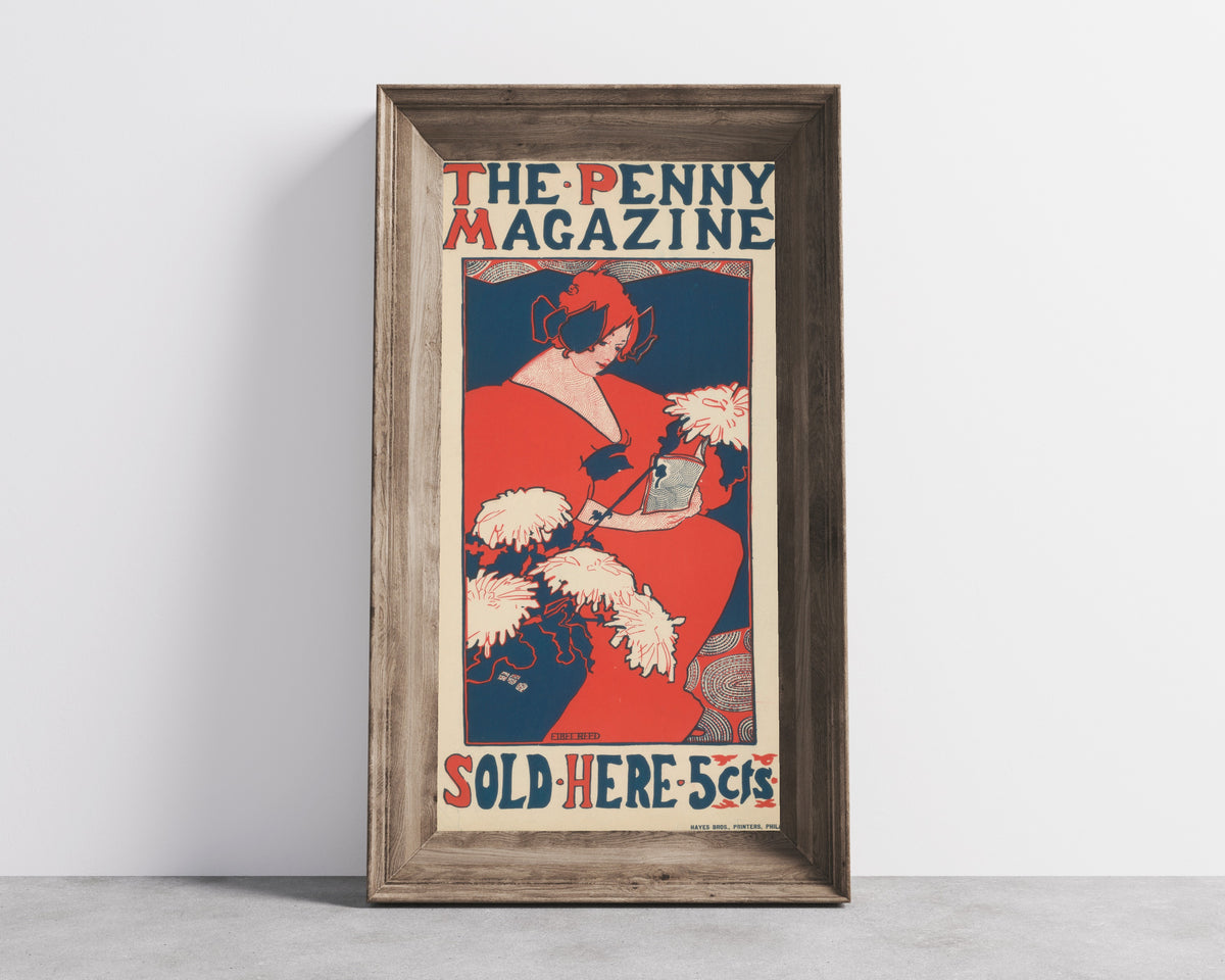 Framed art print of The Penny Magazine by Ethel Reed, in a wide wooden frame leaning against a concrete wall