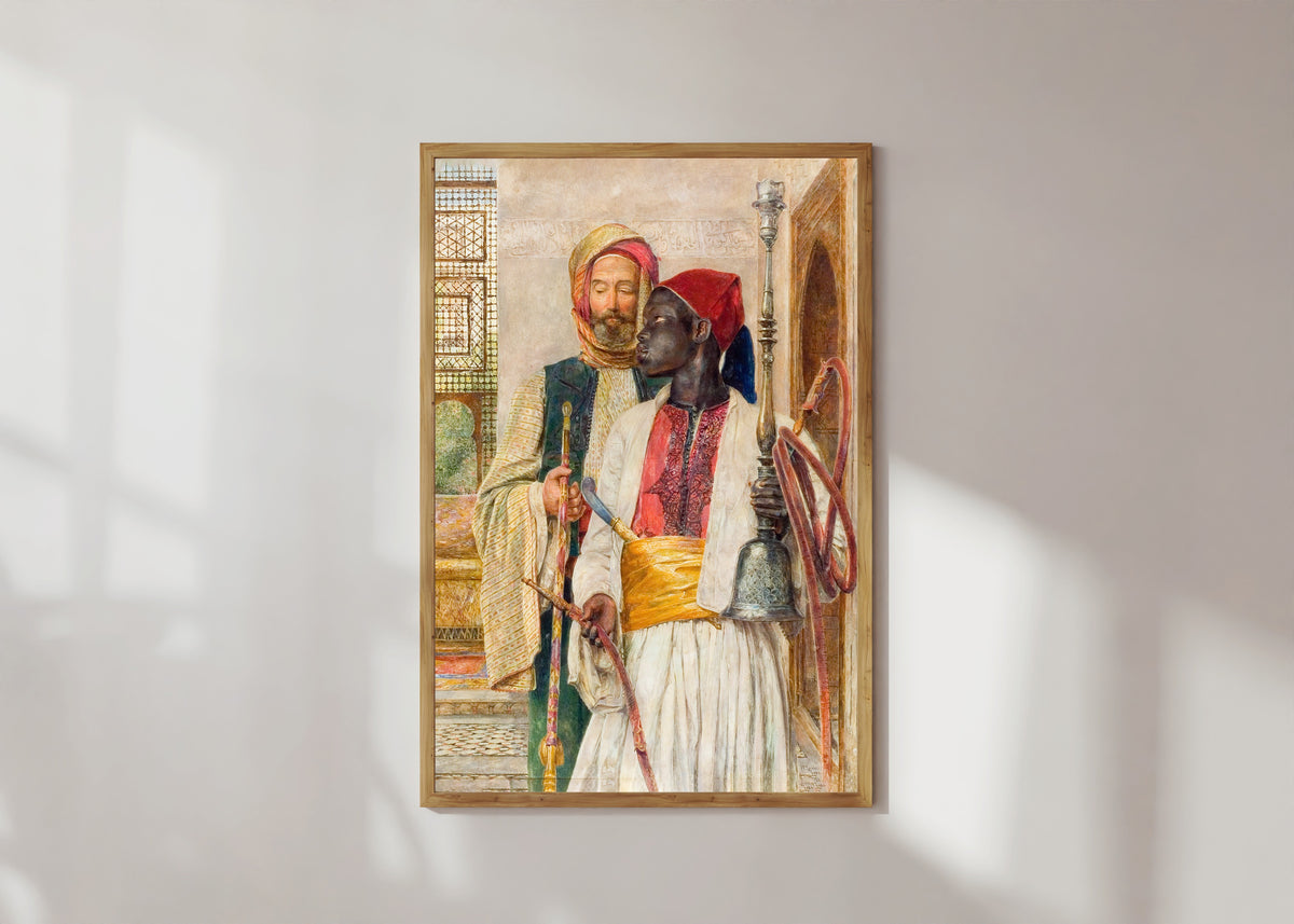 Framed art print of The Pipe Bearer by John Frederick Lewis, in a light wood frame on a sunlit white wall