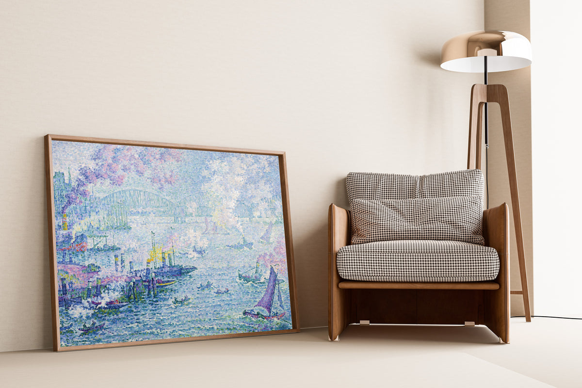 Framed art print of The Port of Rotterdam by Paul Signac, leaning against a wall beside an armchair and a floor lamp