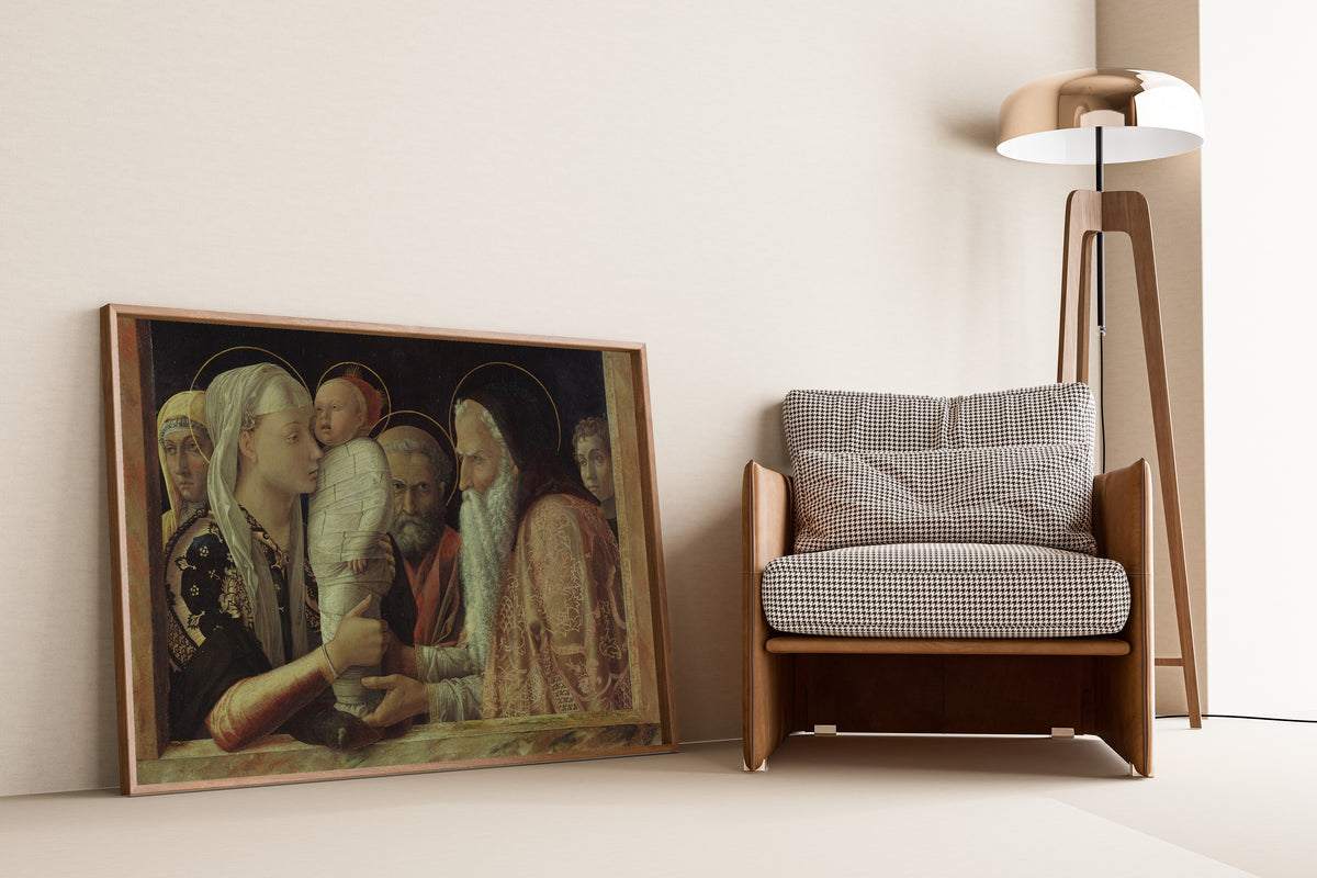 Framed art print of The Presentation by Andrea Mantegna, leaning against a wall beside an armchair and a floor lamp