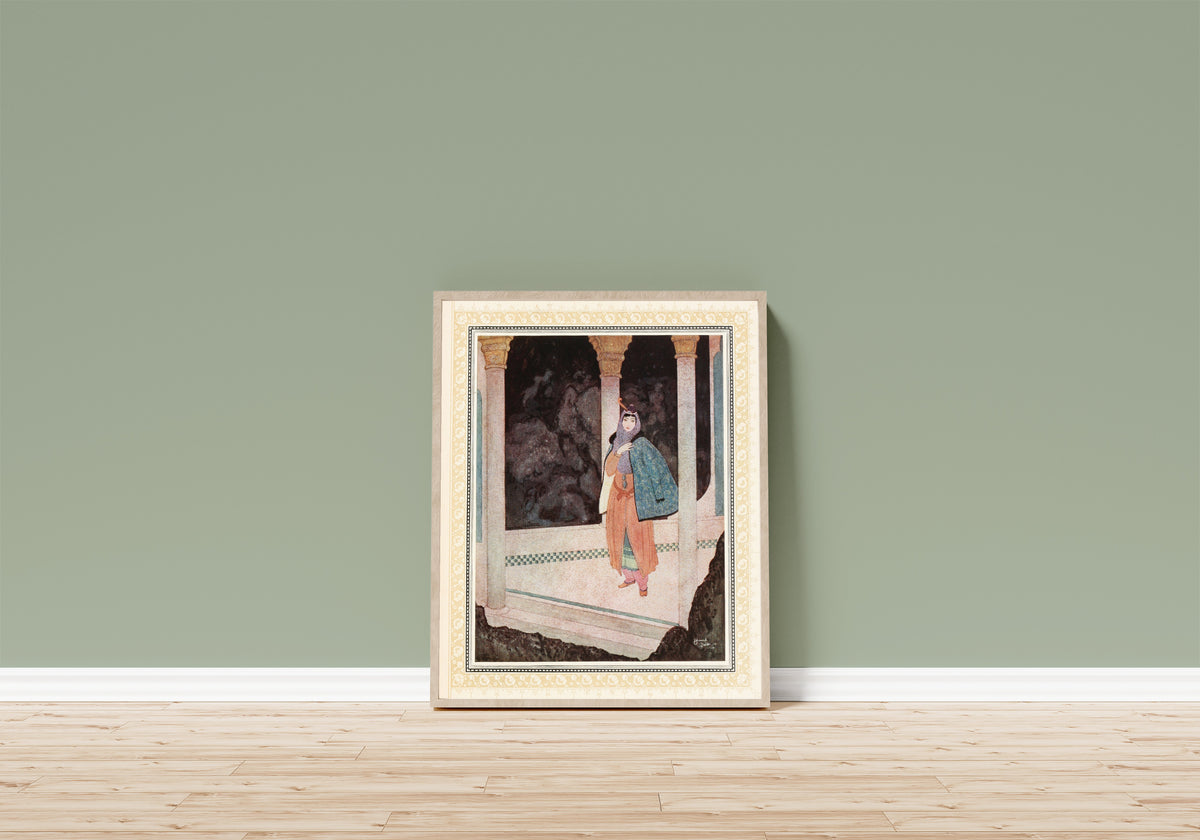 Framed art print of The Prince meets a noble Lady in the Underground… by Edmund Dulac, in a light wood frame leaning on a sage green wall above a wooden floor