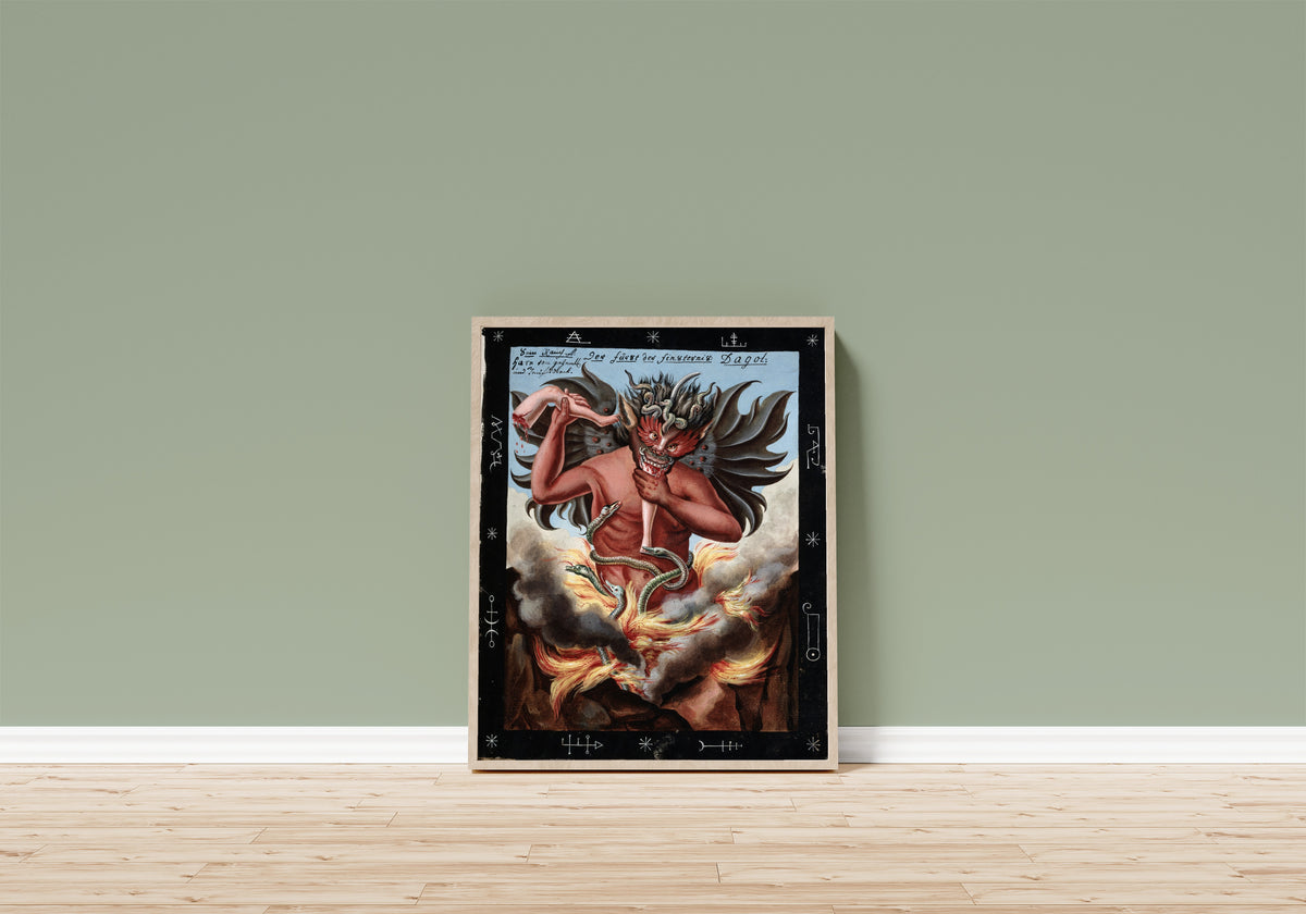 Framed art print of The Prince of Darkness; Dagol by Unknown artist, in a light wood frame leaning on a sage green wall above a wooden floor
