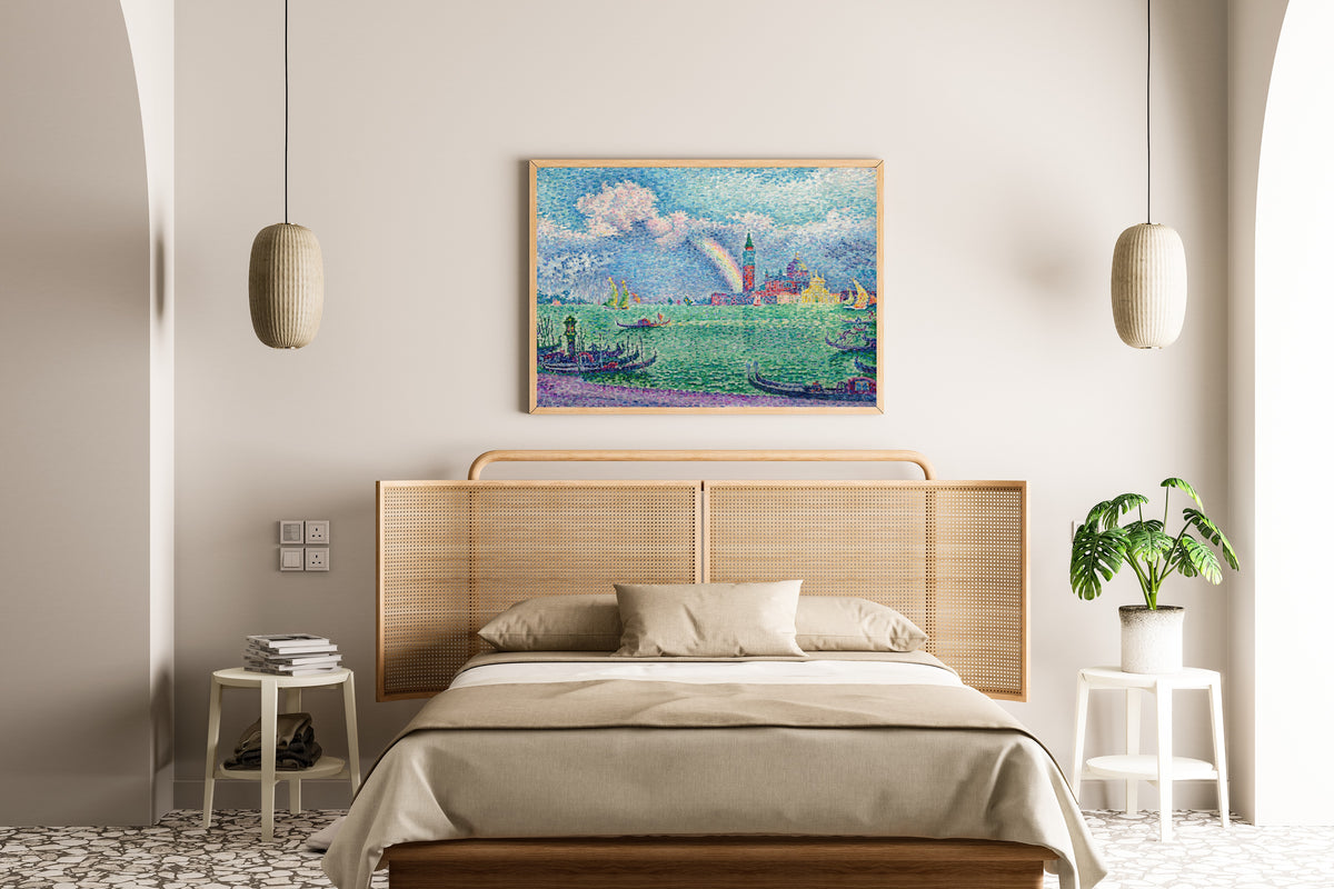 Framed art print of The Rainbow, Venice by Paul Signac, above a cane-headboard bed
