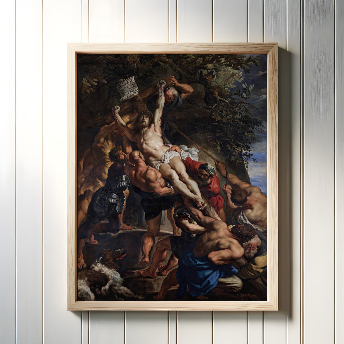 Framed art print of The Raising of the Cross (Central Panel) by Peter Paul Rubens, in a light wood frame on a white panelled wall