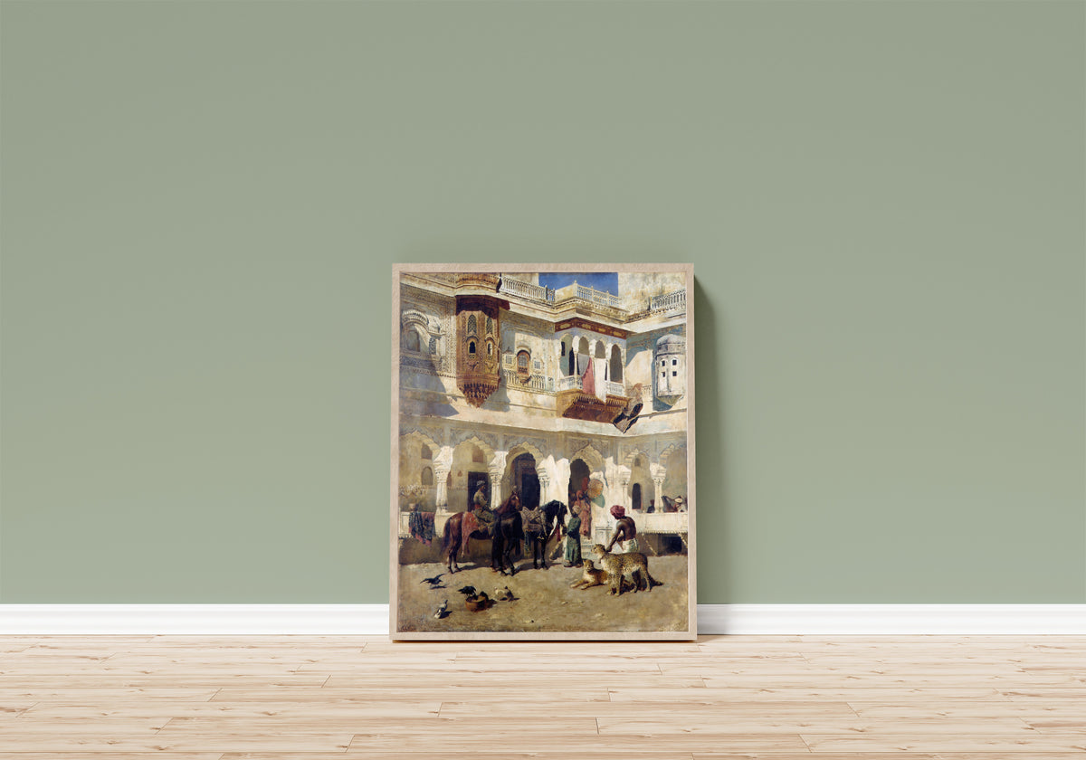 Framed art print of The Rajah Starting on a Hunt by Edwin Lord Weeks, in a light wood frame leaning on a sage green wall above a wooden floor