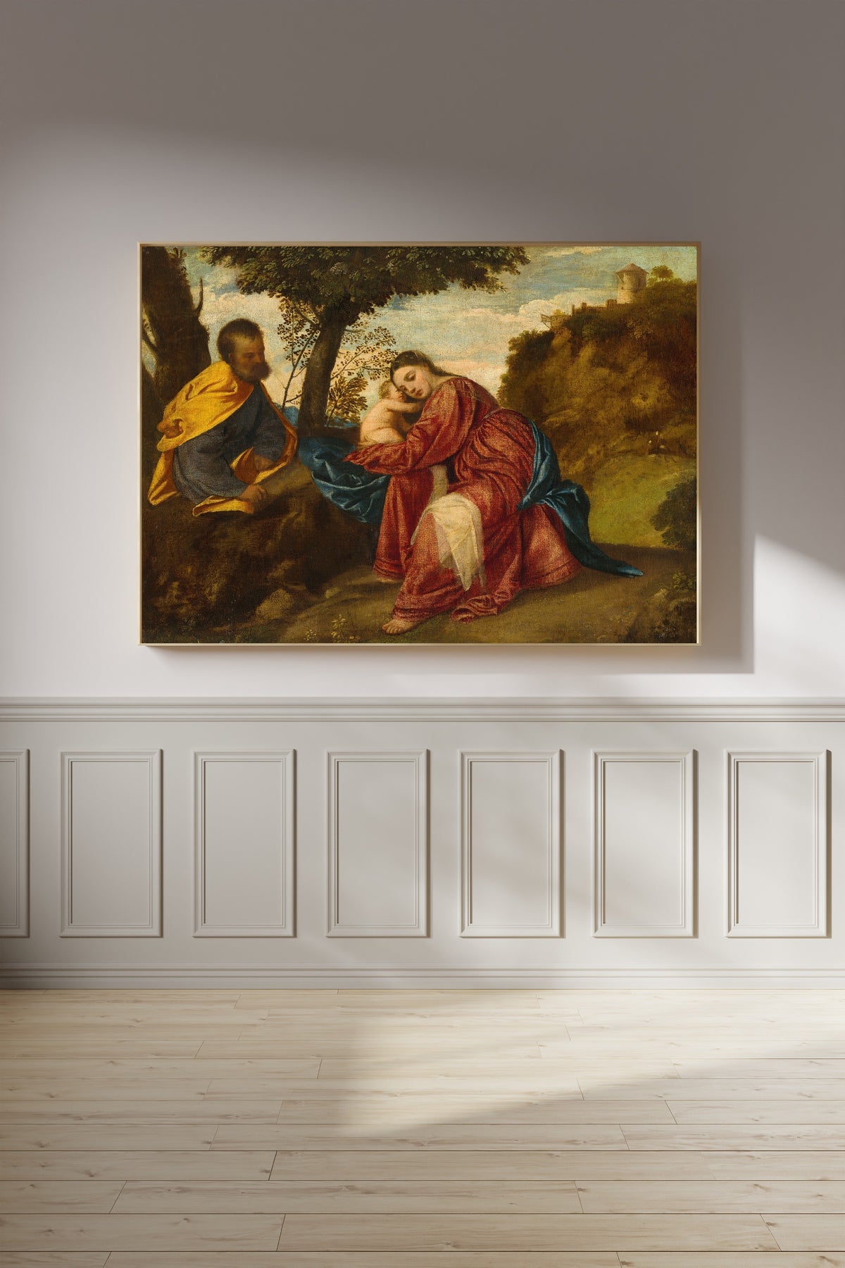Framed art print of The Rest on the Flight into Egypt by Titian, on a panelled wall in afternoon light
