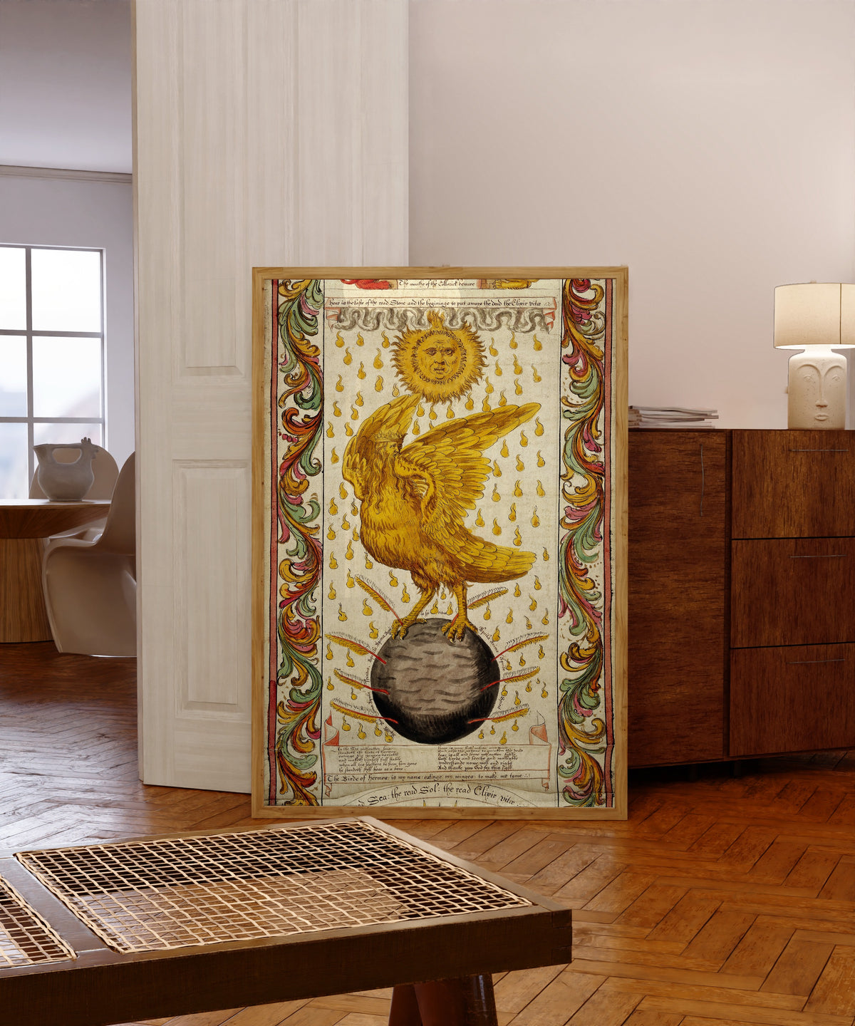 Framed art print of The Ripley Scroll: The Golden Winged Bird on the Black… by George Ripley, in a light wood frame leaning in a warm room with a parquet floor
