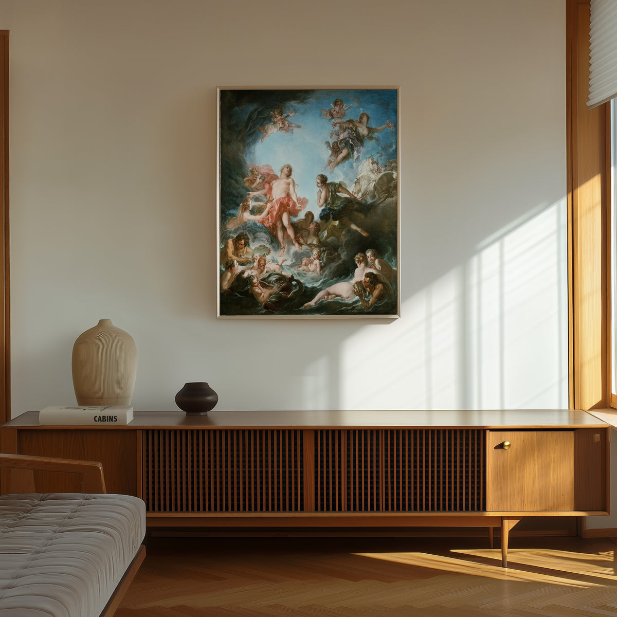 Framed art print of The Rising of the Sun by François Boucher, in a thin light frame on a sunlit wall above a wooden sideboard