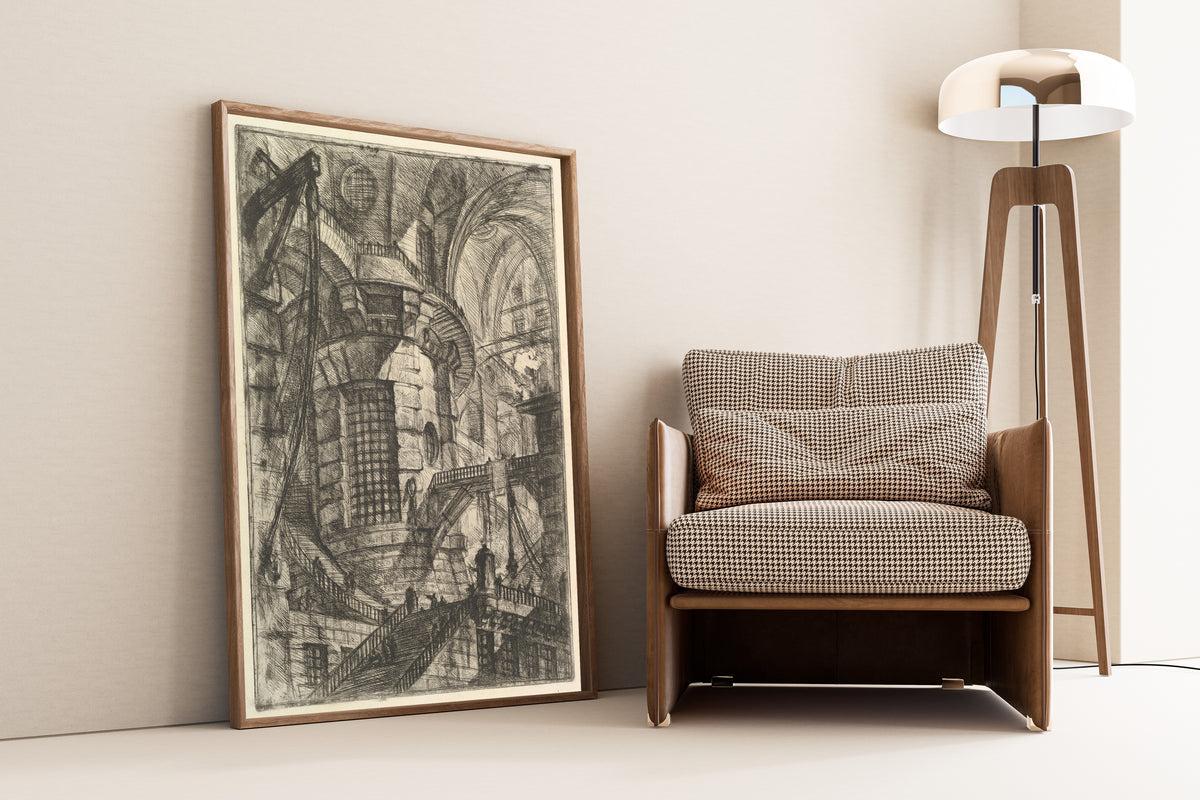 The Round Tower by Giovanni Battista Piranesi — framed and leaning against a wall beside an armchair and a floor lamp