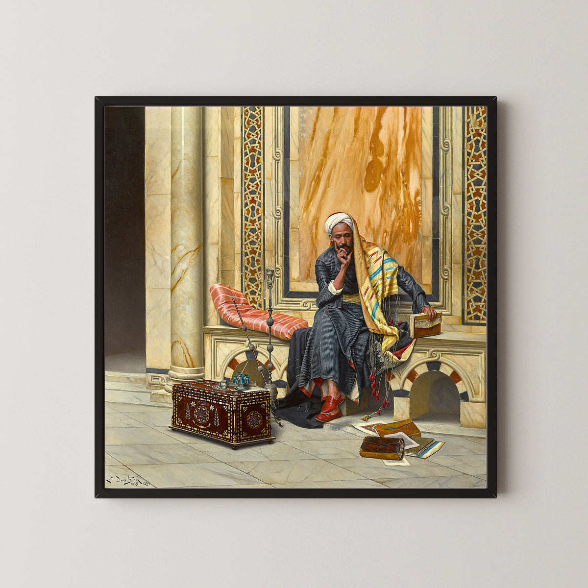 Framed art print of The Scribe by Ludwig Deutsch, in a black frame on a pale wall
